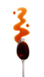 Traditional soy sauce and spoon on white background, top view