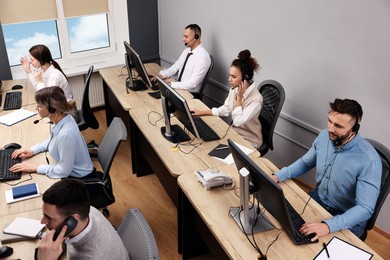 Call center operators working in modern office, above view