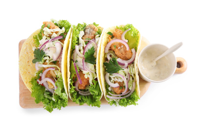 Yummy fish tacos with sauce isolated on white, top view