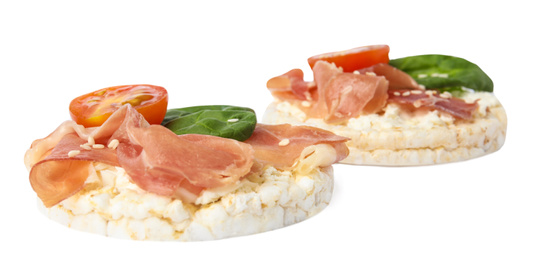 Puffed rice cakes with prosciutto, tomato and basil isolated on white