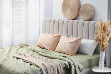 Bed with new pistachio linen in room. Interior design