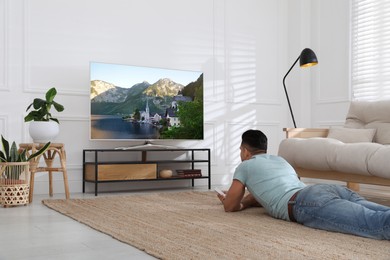 Man watching television at home. Living room interior with TV on stand