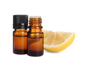 Bottles of citrus essential oil and cut fresh lemon isolated on white