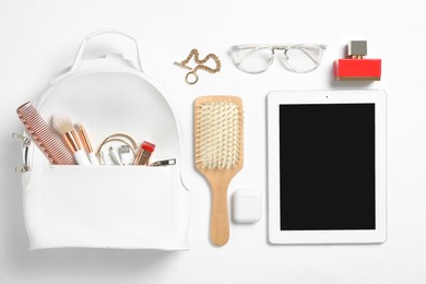 Stylish urban backpack with different items on white background, flat lay