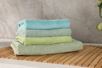 Stack of clean towels on countertop in laundry room