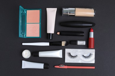 Set of makeup products on black background, flat lay