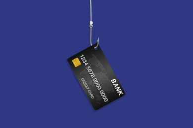Hook with credit card on blue background. Cyber crime
