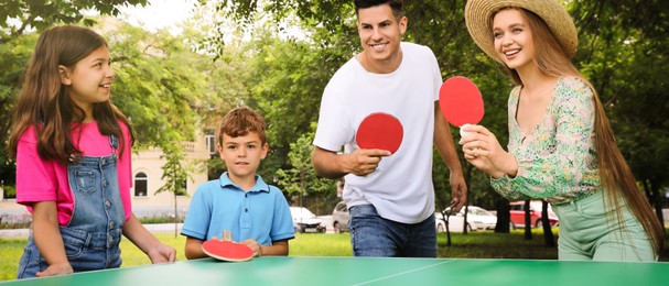 Happy family playing ping pong in park. Banner design