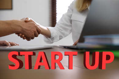 Image of Business partners shaking hands at table, closeup. Startup idea