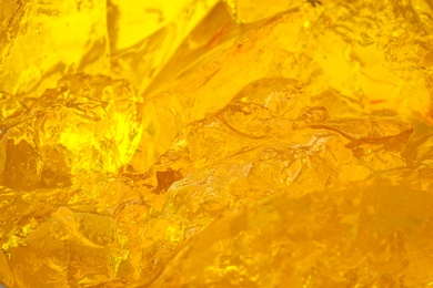 Delicious yellow fruit jelly as background, closeup