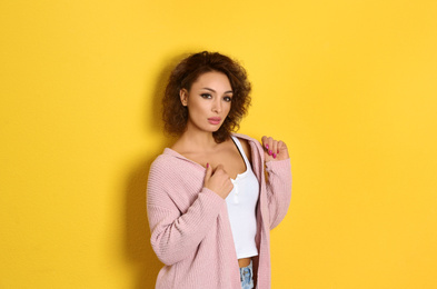 Beautiful woman in casual outfit on yellow background