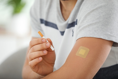 Man with nicotine patch and cigarette, closeup