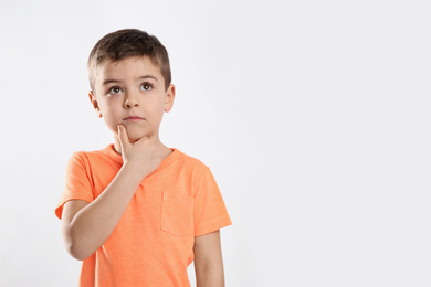 Photo of Emotional little boy in casual outfit on white background