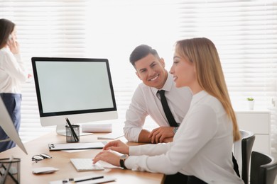 Photo of Man flirting with his colleague during work in office