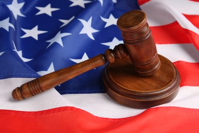 Judge's gavel on national American flag, closeup