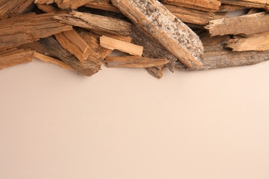 Photo of Wood chips on beige background, flat lay. Space for text