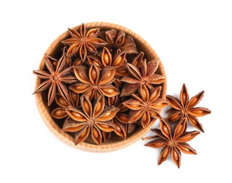 Wooden bowl and dry anise stars on white background, top view
