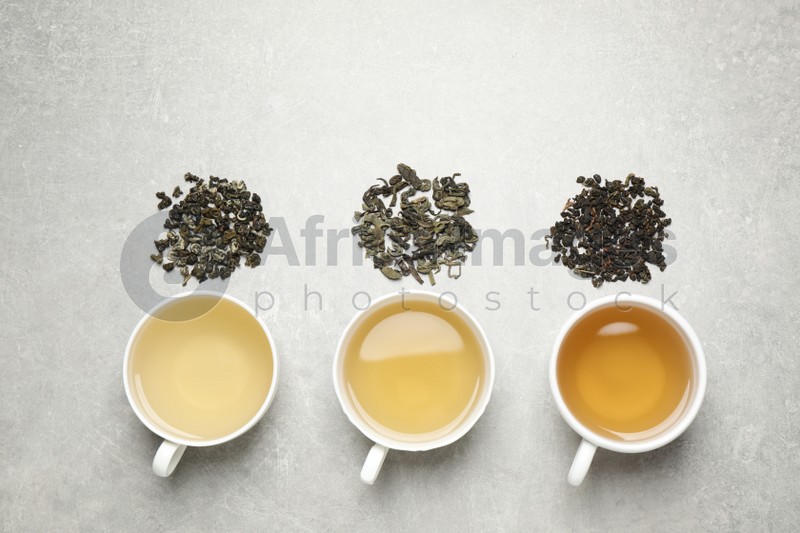 Flat lay composition with green tea on grey table
