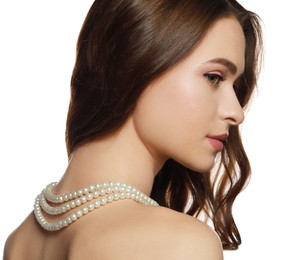 Photo of Young woman wearing elegant pearl necklace on white background