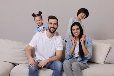 Portrait of happy family on sofa in living room