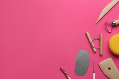 Set of clay modeling tools on pink background, flat lay. Space for text
