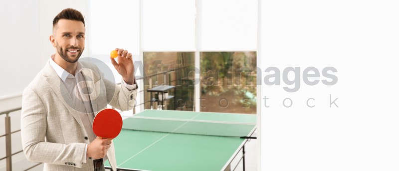 Image of Businessman with tennis racket and ball near ping pong table in office. Space for text. Banner design