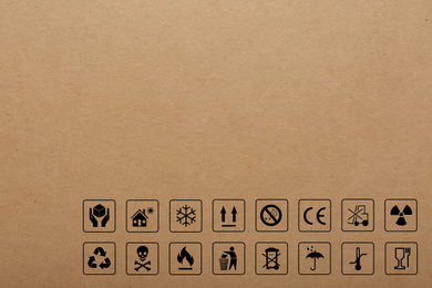 Cardboard box with packaging symbols as background, closeup