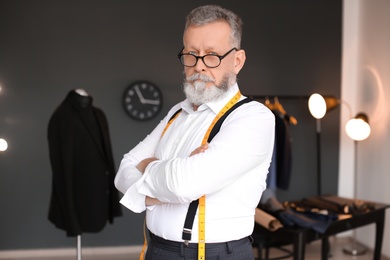 Portrait of mature tailor in atelier