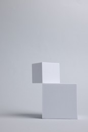 Scene with podium for product presentation. Cubes on light grey background