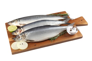 Photo of Wooden board with salted herrings, onion, lime, spices and rosemary isolated on white