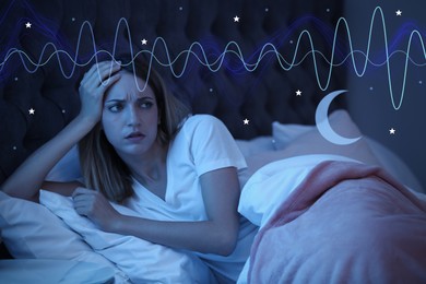 Young woman suffering from insomnia in bed at night. Problem of sleep deprivation