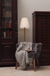 Photo of Library interior with wooden furniture and comfortable place for reading