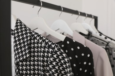 Rack with stylish clothes in dressing room
