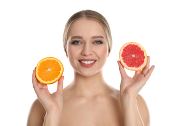 Photo of Young woman with cut orange and grapefruit on white background. Vitamin rich food
