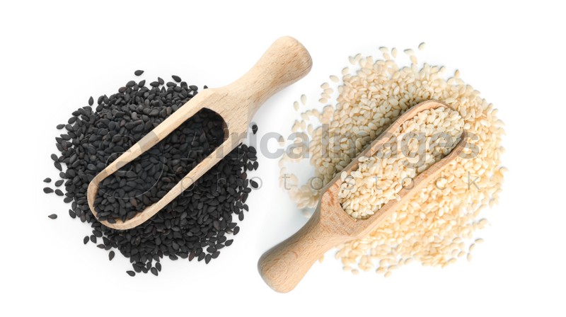 Set with different sesame seeds on white background, top view