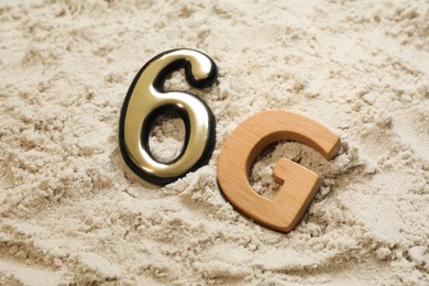 6G technology, Internet concept. Number and letter on white sand, closeup