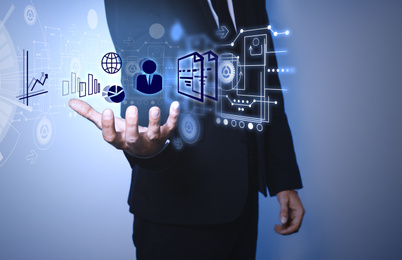  Man demonstrating icons of data management system on light background, closeup