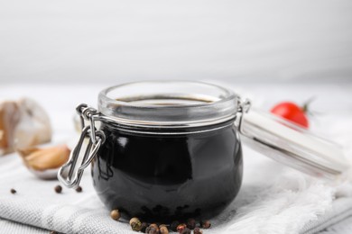 Photo of Organic balsamic vinegar and cooking ingredients on table, closeup