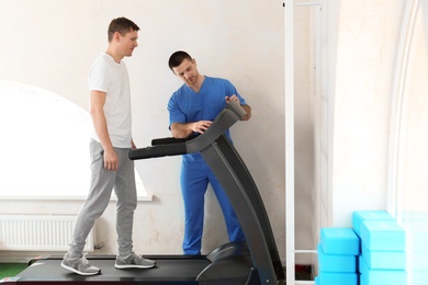Patient exercising under physiotherapist supervision in rehabilitation center