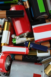 Many batteries of different types as background, above view