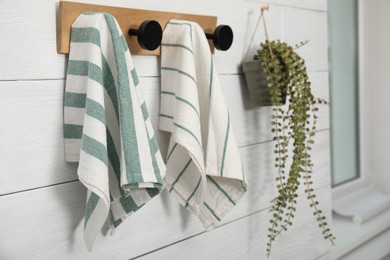 Different clean kitchen towels hanging on rack