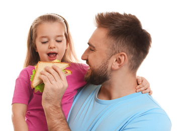 Photo of Young man and his daughter with sandwich on white background