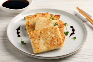 Delicious turnip cake served on white wooden table