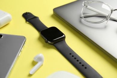 Composition with stylish smart watch on yellow background
