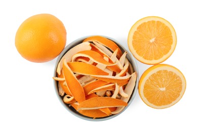 Photo of Bowl with dry orange peels and fresh fruits isolated on white, top view