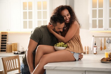 Lovely couple enjoying time together in kitchen at home