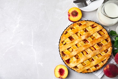 Delicious fresh peach pie served on light grey table, flat lay. Space for text