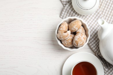 Tasty homemade gingerbread cookies and tea on white wooden table, flat lay. Space for text