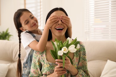 Little daughter congratulating her mom at home. Happy Mother's Day