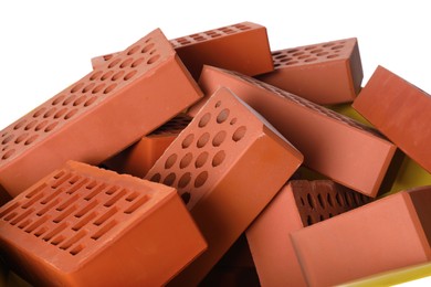 Pile of red bricks on white background, closeup. Building material